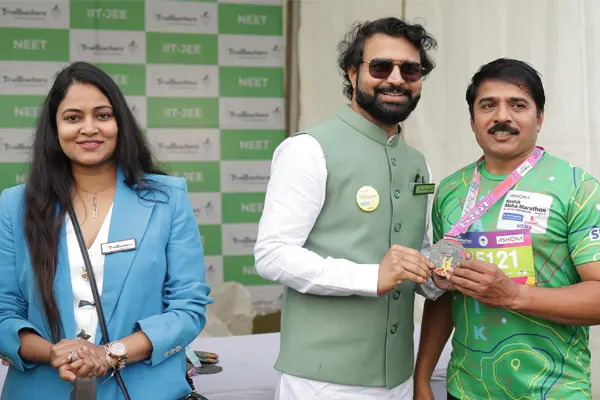 Participants at a sponsored marathon event receiving medals at the finish area