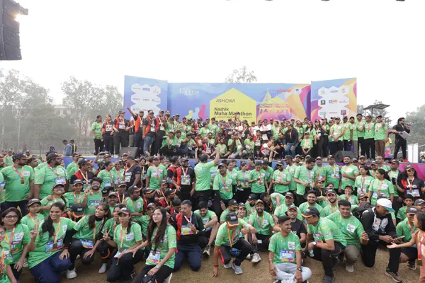 Large group of participants and volunteers posing together at the Nashik Maha Marathon event