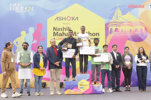 Winners receiving awards on the podium at the Nashik Maha Marathon award ceremony